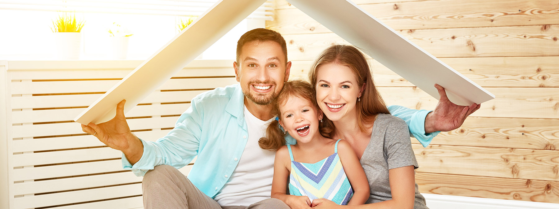 A happy father, mother and daughter in their new home