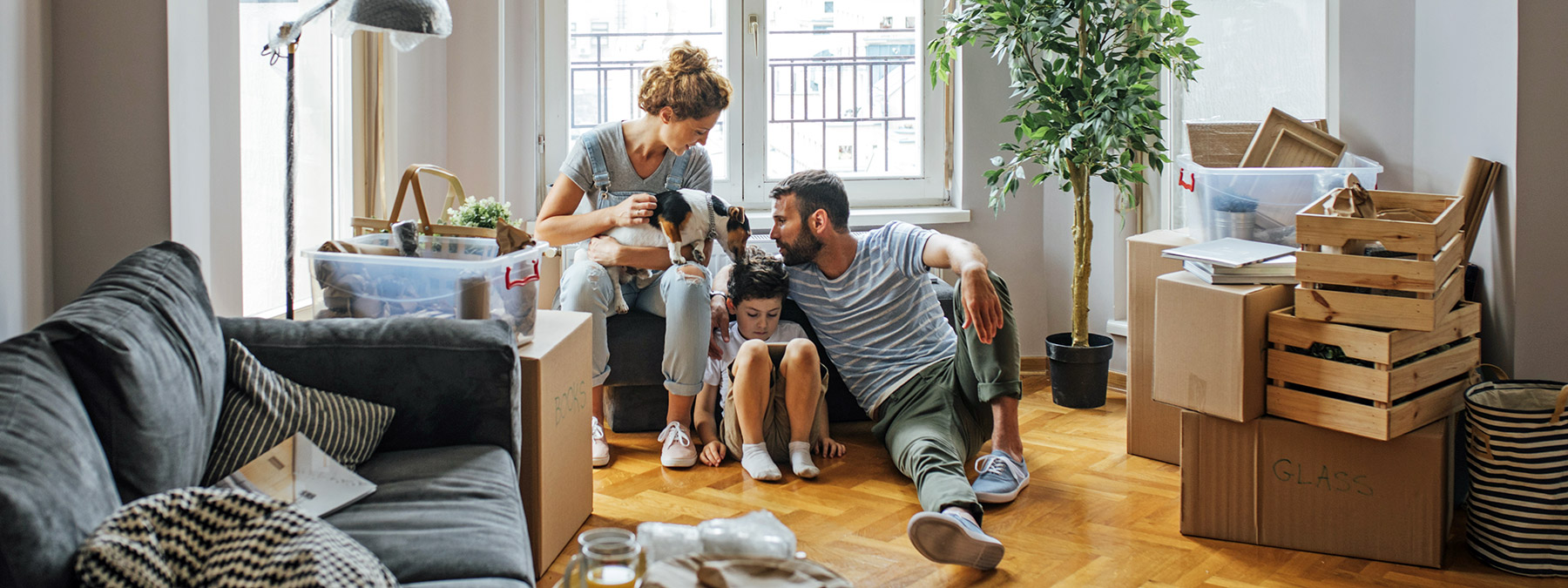 A small family takes a break from unpacking in their new home